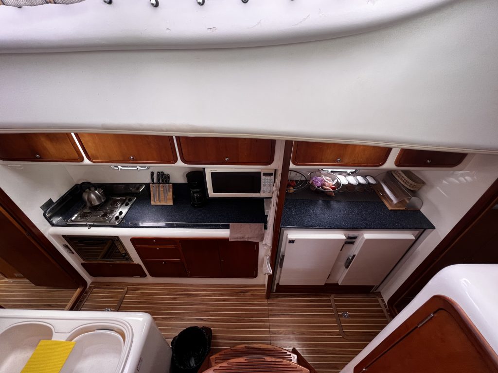 The fully equipped galley aboard Akua Aminata, Sailing Dutchman’s private catamaran, designed for comfortable Caribbean sailing adventures.